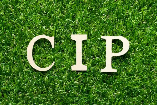 CIP abbreviation standing for Carriage and Insurance Paid To, shown on green grass background