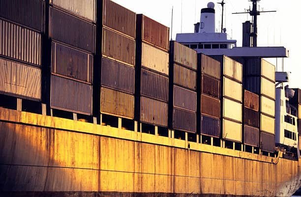 Large cargo ship carrying containers representing freight out shipments