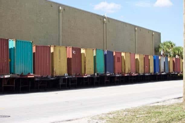 Docked colored containers prepared for loading and outbound shipping