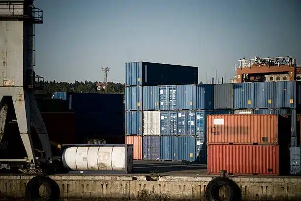 Blue and red export containers prepared for outbound logistics at port