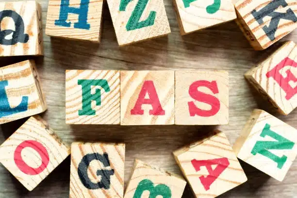 Wooden block letters forming FAS acronym related to shipping Incoterms