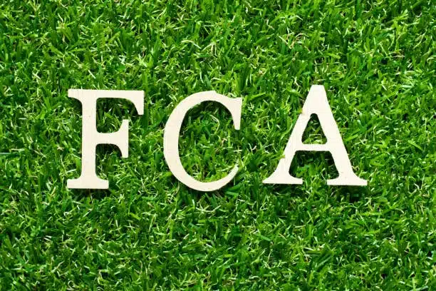 FCA letters positioned on grass symbolizing Free Carrier term in Incoterms