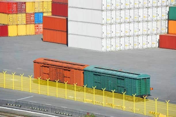 Train containers and storage stacks at freight terminal for export logistics