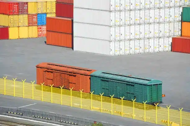 Train containers and storage stacks at freight terminal for export logistics