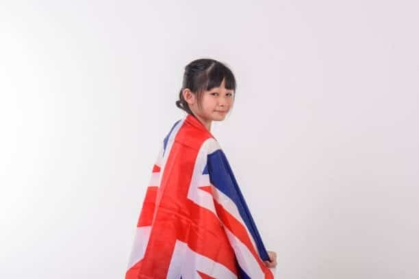 Child wrapped in a UK flag, representing the cultural and commercial link with Malaysian exports