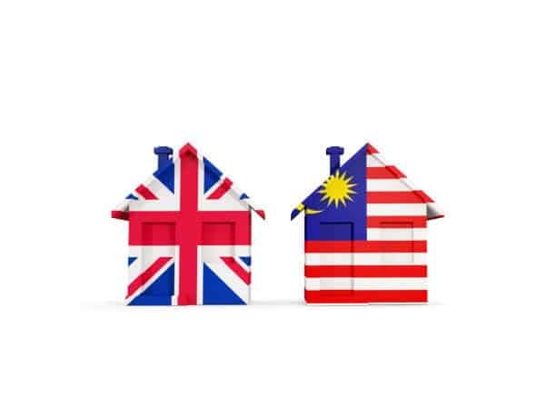 Mini houses decorated with UK and Malaysia flags, symbolizing international relocation and shipping
