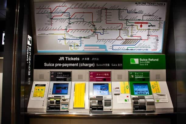Automated rail ticket and payment machines at train station representing port proximity
