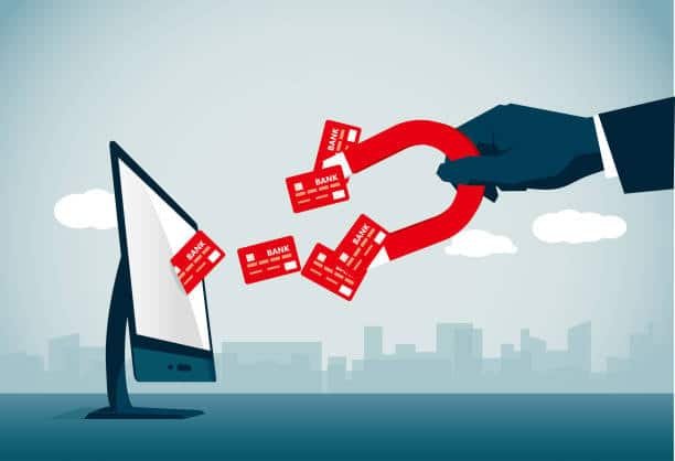 Illustration of magnet pulling bank cards from a computer, symbolizing payment capture