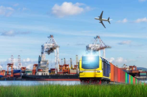A train with multicolored containers moving along tracks, used for freight transport to Côte d'Ivoire.