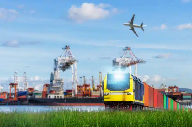 A train with multicolored containers moving along tracks, used for freight transport to Côte d'Ivoire.