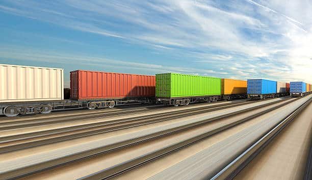 A stylized image of a shipping hub featuring a ship, plane, truck, and crane, representing logistics in Côte d'Ivoire.