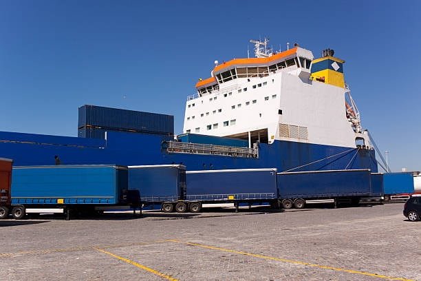 Roll-on/roll-off vessel with trucks and trailers ready to be loaded onboard