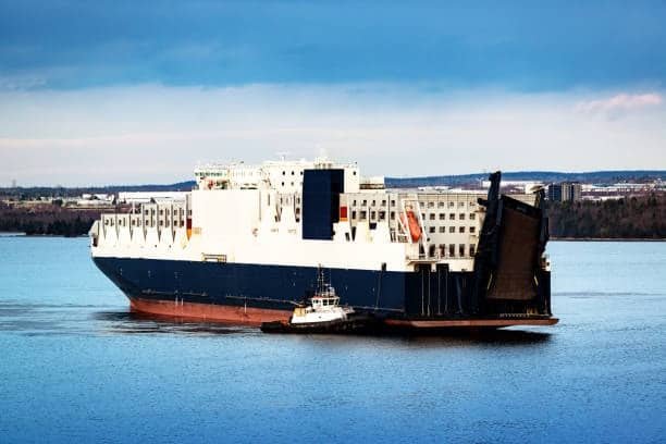 Roll-on/roll-off ship with ramp open, ready to load large vehicles and heavy cargo