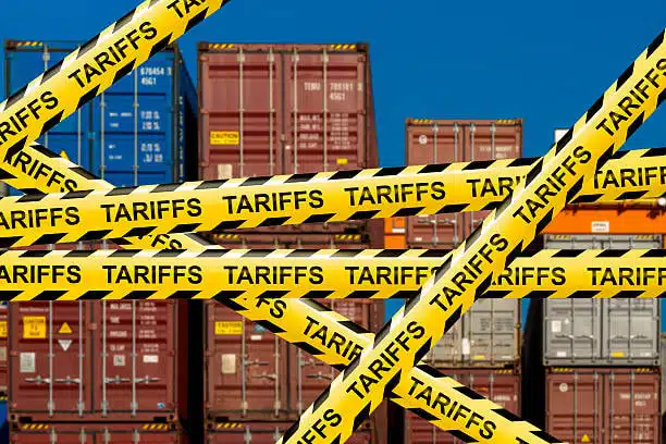 Export containers restricted by tariff warning tape in logistics yard