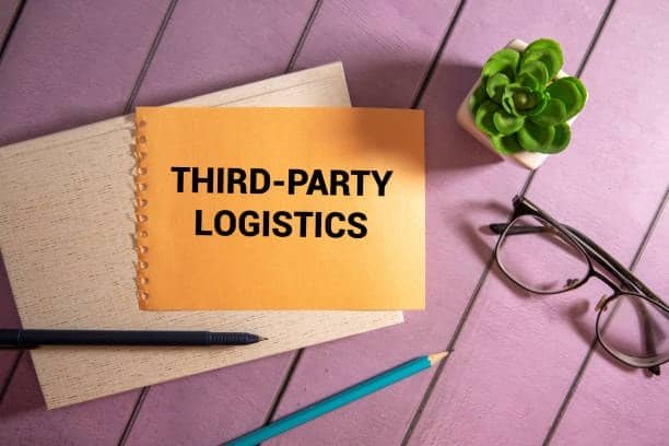 Notebook with third-party logistics text next to glasses, pencil, and small plant