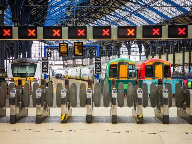 International train station with gates and freight trains representing export shipping