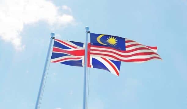 National flags of Malaysia and the UK representing international shipping partnership