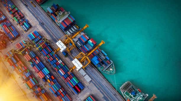 Aerial view of colorful containers and cargo vessels at port