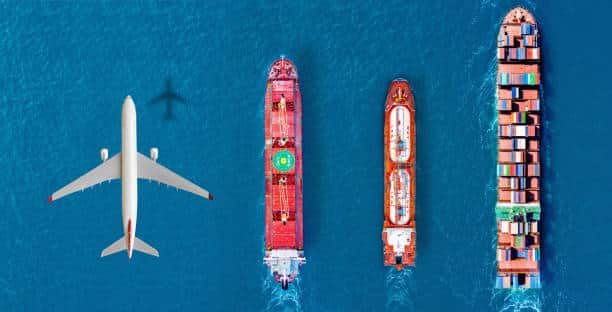 Airplane flying above cargo ships in ocean, highlighting international sea and air shipping to Tanzania