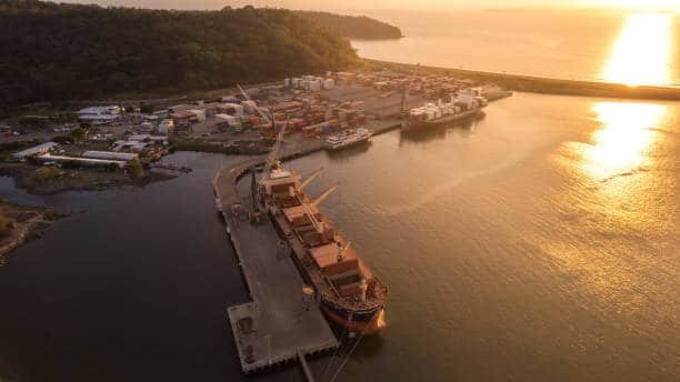 Sunset aerial view of Puerto Caldera shipping port in Costa Rica with cargo ships docked