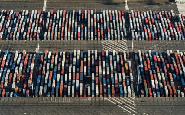 Aerial top view of shipping containers arranged in a large export yard