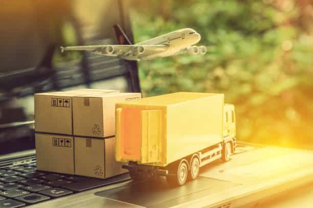Airplane and delivery truck model with cardboard boxes representing global shipping