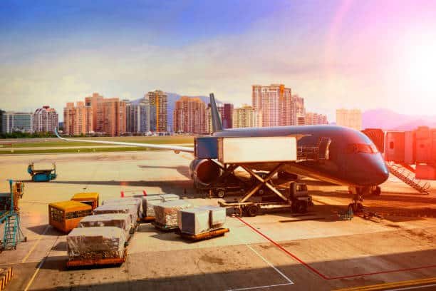 Cargo being loaded onto a commercial plane at an airport for shipping to Kenya.