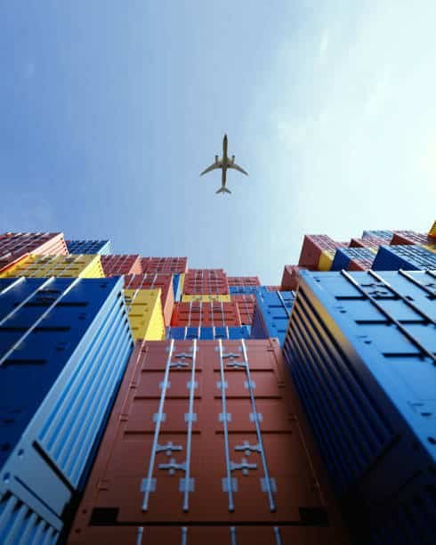 Airplane flying above containers symbolizing air freight from China to Somalia