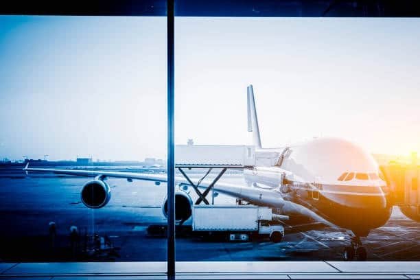 Wide-body cargo plane being loaded at airport gate in China for international air freight shipment