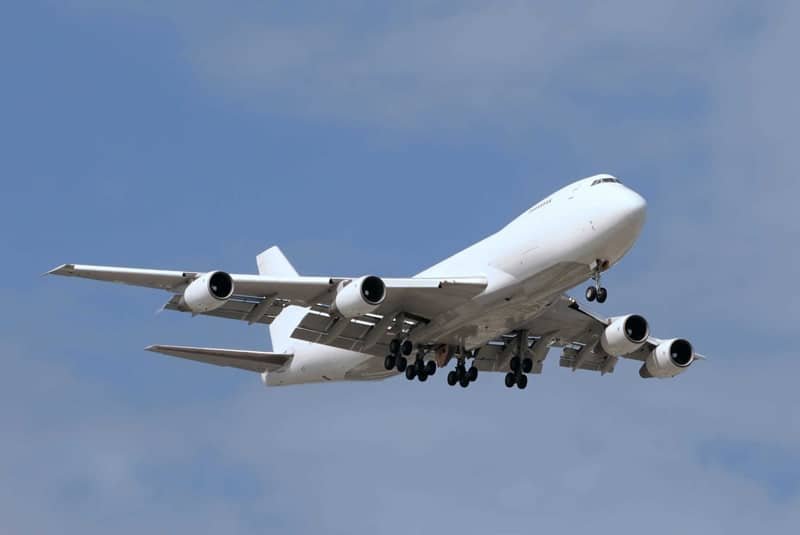 Cargo airplane in flight, representing fast and reliable air freight services with major carriers like DHL, FedEx, and UPS.