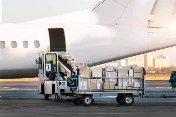Pallet of parcels being transferred onto airplane for air freight shipment