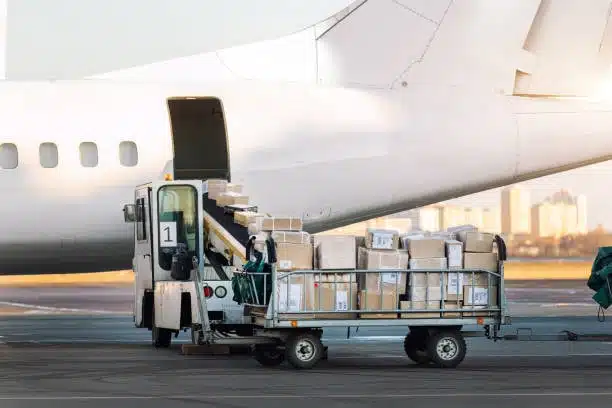Pallet of parcels being transferred onto airplane for air freight shipment