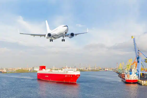 Red cargo ship near port with airplane landing – China to Sweden air and sea cargo logistics