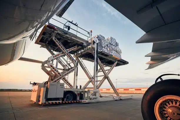 Cargo loader lifting goods into aircraft for shipping from China to Bangladesh