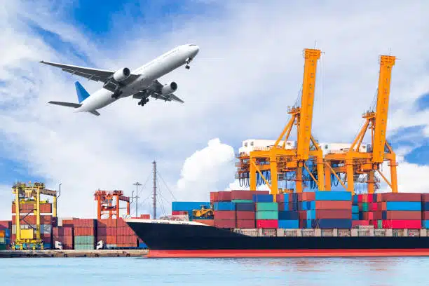 Airplane taking off above cargo cranes and containers, showing air-sea shipping services to Hungary.