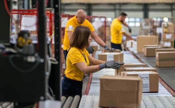 Workers sorting Alibaba parcels on conveyor belt