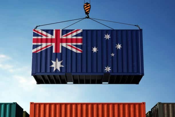 Container with Australian flag being lifted by crane at port terminal