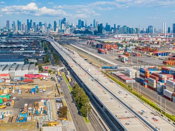 Aerial view of Australian freight port and infrastructure connecting to the city