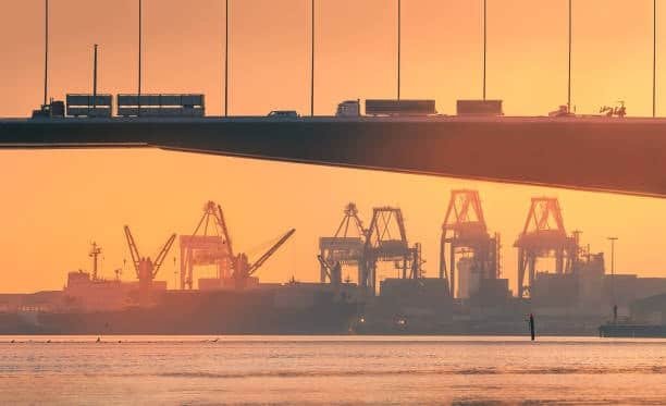 Shipping cranes silhouetted at sunset in an Australian port