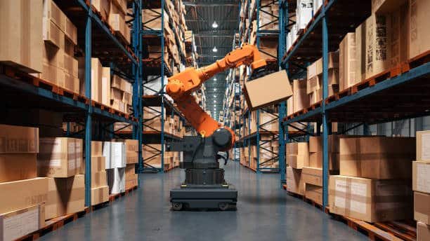 Robotic arm moving packages in an automated warehouse