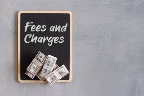 Blackboard with “Fees and Charges” and cash bundles—symbolizing CFS shipping cost calculation