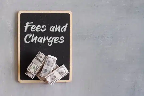 Blackboard with “Fees and Charges” and cash bundles—symbolizing CFS shipping cost calculation
