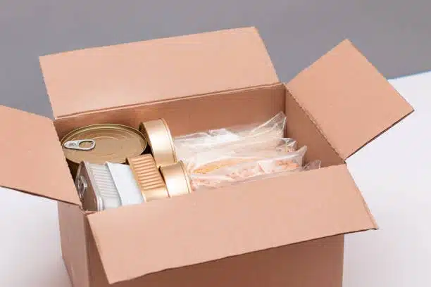 Delivery-ready box containing canned food and vacuum-packed meals designed for perishable food shipping.