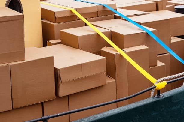 Multiple cardboard boxes tied with safety straps for shipping