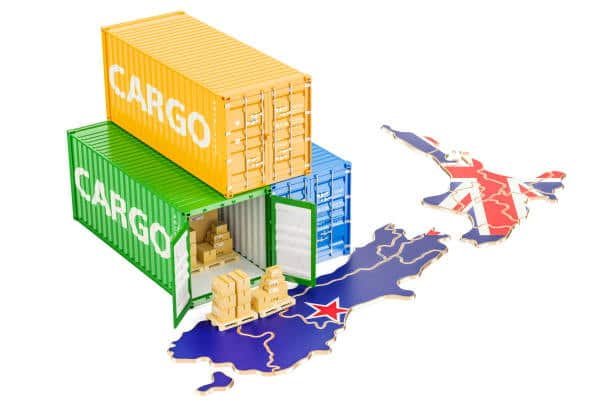 Freight containers stacked on map of New Zealand representing goods import and export