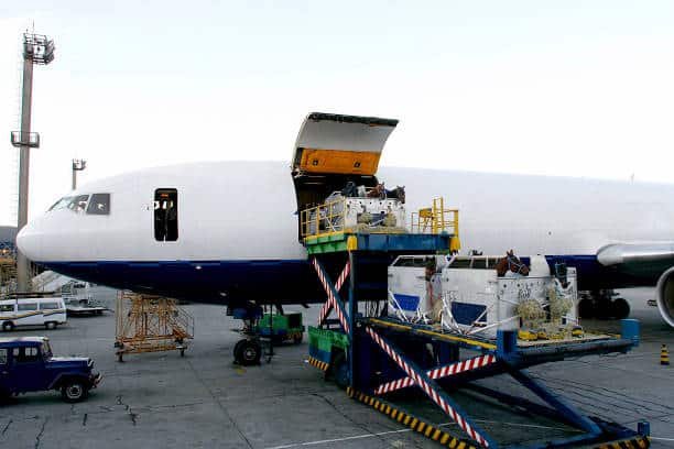 Cargo containers being loaded onto a freight airplane at an international airport