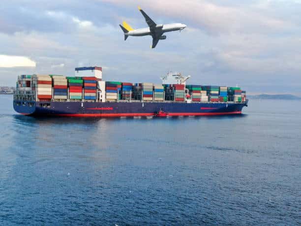 Cargo ship at sea with airplane overhead, illustrating freight transport from China to Belgium.
