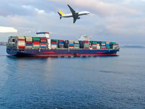 Cargo ship at sea with airplane overhead, illustrating freight transport from China to Belgium.