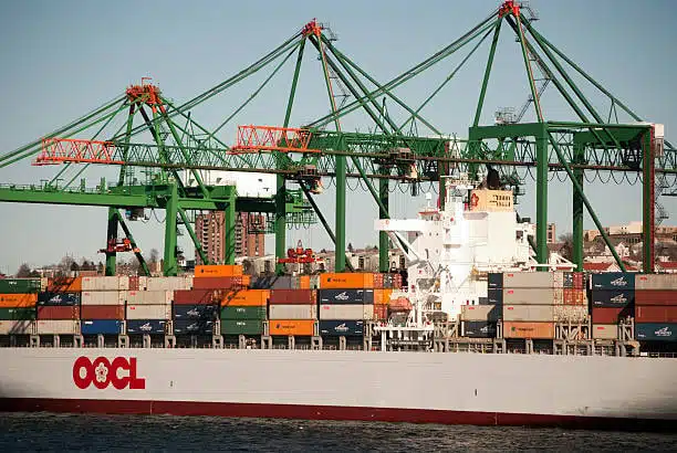 Freight ship being loaded at shipping terminal