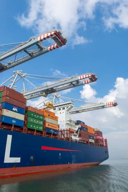 Cranes loading containers onto a freight vessel